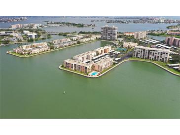 Waterfront condos surrounded by water with a community pool, boat docks and assigned parking at 7645 Sun Island S Dr # 207, South Pasadena, FL 33707