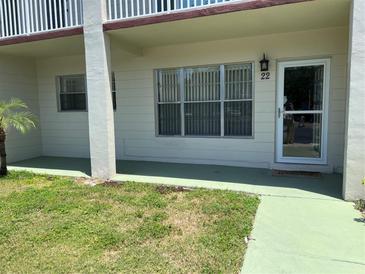 Charming condo with a well-maintained lawn and front entrance with number 22, enhancing curb appeal at 2434 Australia E Way # 22, Clearwater, FL 33763