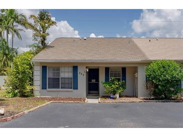 Inviting single-story home featuring blue shutters, a cozy front entrance, and well-maintained landscaping at 333 Bay Pl, Safety Harbor, FL 34695