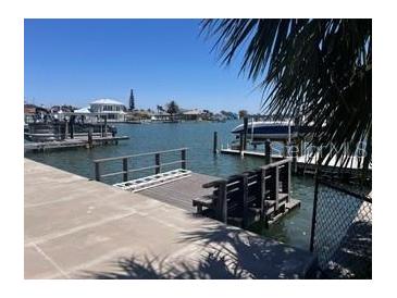 Waterfront property featuring a private boat dock and tranquil views of the waterway at 510 64Th Ave, St Pete Beach, FL 33706