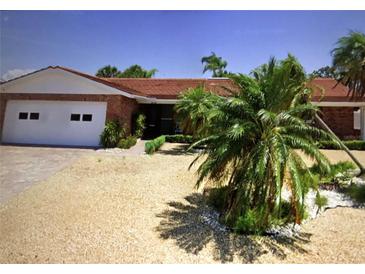 Charming single-story brick home with well-maintained landscaping and attached two-car garage at 510 64Th Ave, St Pete Beach, FL 33706
