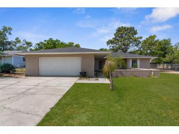 Charming single-story home with a two-car garage and well-manicured lawn at 5193 Higate Rd, Spring Hill, FL 34609