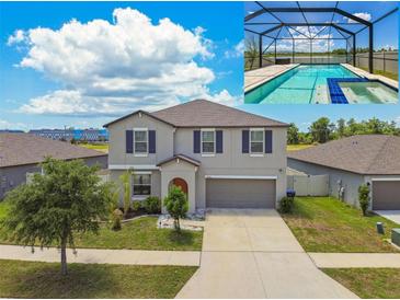 Two-story home featuring a private screened-in pool and a well-manicured lawn at 11504 Sage Canyon Dr, Riverview, FL 33578