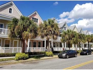 Charming multi-level townhomes with colorful exteriors, balconies, and lush tropical landscaping in a sunny neighborhood at 2002 E 5Th Ave # 110, Tampa, FL 33605