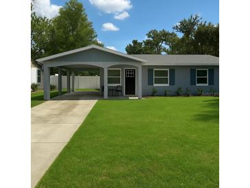 Charming home with a well-manicured front yard, covered parking, and inviting curb appeal at 2205 N Grady Ave, Tampa, FL 33607