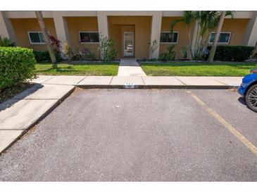 Assigned parking space steps away from the building entrance and is adjacent to the sidewalk at 2231 Utopian E Dr # 117, Clearwater, FL 33763