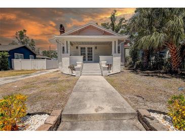 Charming home with classic architecture, featuring a welcoming front porch and landscaped walkway at 4519 5Th S Ave, St Petersburg, FL 33711