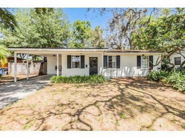 Charming one-story home with a covered front porch and beautiful landscaping at 7603 N 53Rd St, Tampa, FL 33617