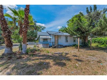 Charming single-story home with a classic design, featuring a front porch, tropical foliage, and a tranquil setting at 2001 29Th N Ave, St Petersburg, FL 33713