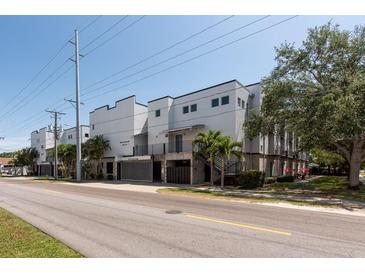 Modern apartment building featuring a clean design with palm trees and well-maintained landscaping at 5008 S Macdill Ave # 10, Tampa, FL 33611