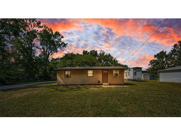 Charming single-story home featuring a well-maintained lawn, and a welcoming front entrance at 6423 Bass Rd, Weeki Wachee, FL 34607