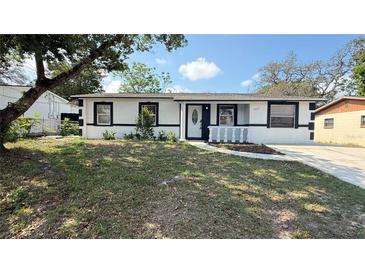 Charming single-story home featuring a well-maintained lawn and a welcoming entrance at 7017 Baywood Dr, Tampa, FL 33637