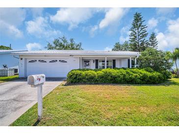 Charming home featuring a well-maintained lawn and a welcoming front entrance at 9136 42Nd N Ln, Pinellas Park, FL 33782