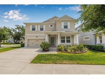 Charming two-story home features a well-manicured lawn, two-car garage, and lovely curb appeal at 14718 Rocky Brook Dr, Tampa, FL 33625