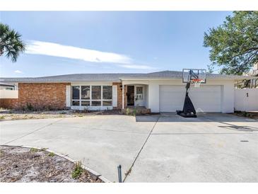 Charming single-story home with a brick facade, bright white trim, and a spacious two car garage at 2140 Dolphin S Blvd, St Petersburg, FL 33707