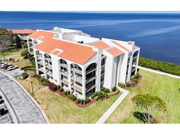 Stunning waterfront condo featuring a red tile roof and lush landscaping at 433 Mariner Dr # 433, Tarpon Springs, FL 34689