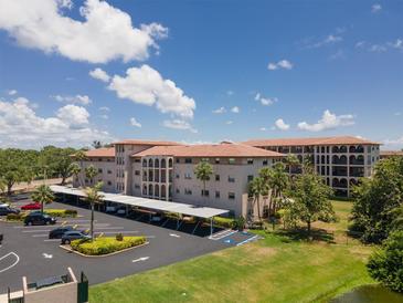 Exterior of Golfview Condominiums featuring covered parking, lush landscaping, and building architecture at 6150 Gulfport S Blvd # 306, Gulfport, FL 33707