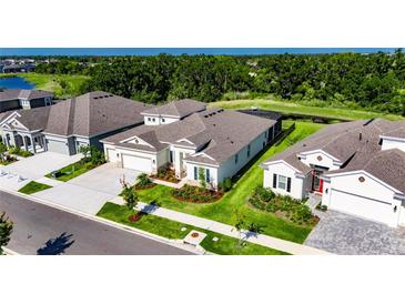 Well-manicured lawn frames this lovely home with a pristine roofline at 6253 Hidden Branch Dr, Apollo Beach, FL 33572