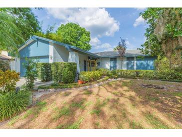 Charming single-story home featuring a well-maintained lawn and manicured shrubbery along the walkway at 7903 Heather Ct, Tampa, FL 33634