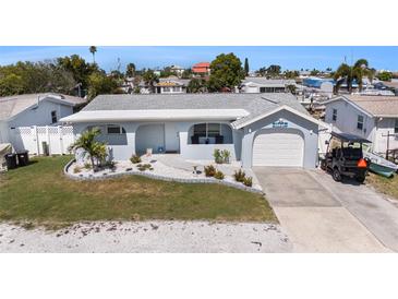 Charming single-story home featuring a well-maintained lawn and attached one-car garage at 13401 Neptune Dr, Hudson, FL 34667