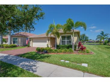 Beautiful single-story home with mature landscaping, brick driveway, and tile roof in an attractive community at 16139 Coquina Bay Ln, Wimauma, FL 33598
