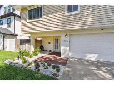 Charming two-story home featuring a well-manicured lawn and a convenient covered parking area at 1735 Maryland Ne Ave, St Petersburg, FL 33703