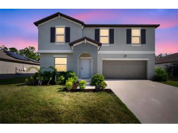 Charming two-story home featuring a well-maintained lawn and a two-car garage at 1823 Moon Cactus Ct, Ruskin, FL 33570