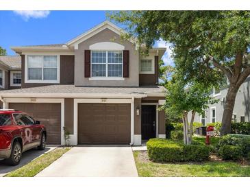Charming two-story townhome featuring a well-manicured lawn and a private garage at 2131 River Turia Cir, Riverview, FL 33578
