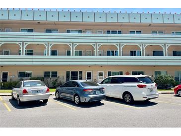 Low-rise condo building with neatly parked cars in the parking area, offering convenient residential living at 2287 Philippine Dr # 29, Clearwater, FL 33763