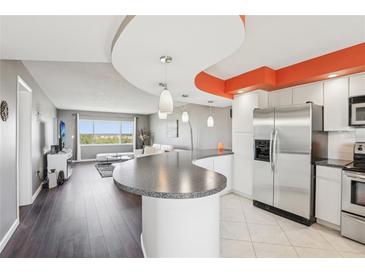 Open concept living room flows into the kitchen and offers amazing water views from a large window at 4725 Cove Cir # 604, St Petersburg, FL 33708