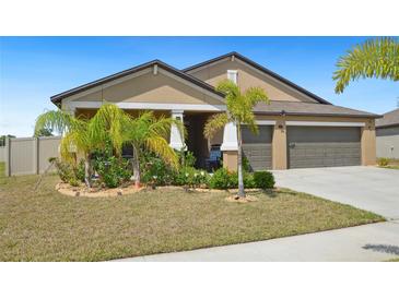 Charming single-story home featuring a well-maintained lawn and a two-car garage at 5457 Leslie Canyon Dr, Wimauma, FL 33598