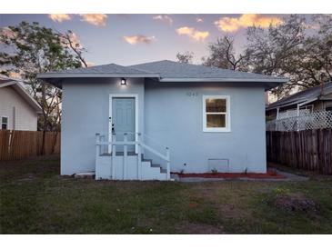 Charming home featuring a light blue exterior with a well-maintained front yard at 1045 22Nd N Ave, St Petersburg, FL 33704