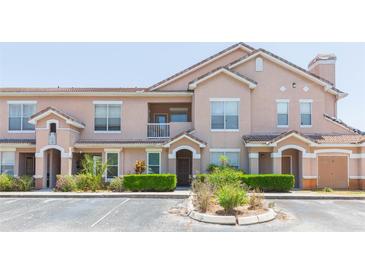 Charming condo featuring a landscaped yard and a classic architectural style with a cozy balcony at 10473 Villa View Cir, Tampa, FL 33647