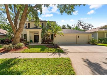 Charming two-story home features a well-manicured lawn and an attached three-car garage at 1133 Split Silk St, Valrico, FL 33594