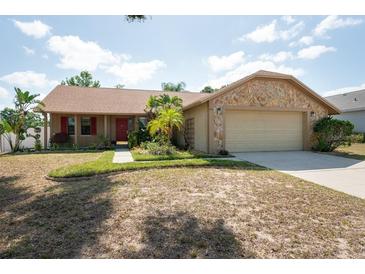 Charming single-Gathering home with a well-manicured lawn and stone accents at 1615 Loghill Pl, Brandon, FL 33510