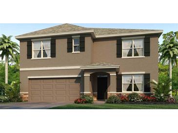 Charming two-story home featuring a two-car garage, landscaped yard, and neutral brown stucco exterior at 32674 Osprey Peak Way, San Antonio, FL 33576