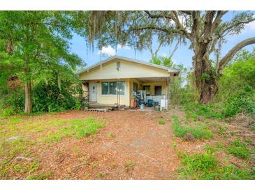 Charming single-story home featuring a covered front porch and mature trees at 3611 W Reynolds St # 1/2, Plant City, FL 33563