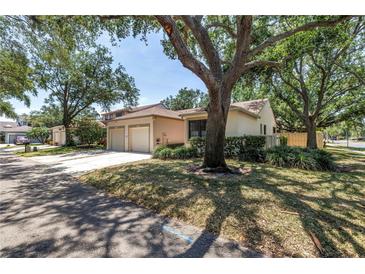 Charming villa-style home with well-maintained landscaping and a two-car garage at 826 Glades Ne Ct, St Petersburg, FL 33702