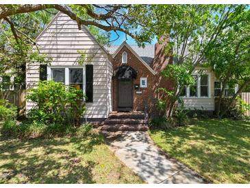 Charming home featuring a brick chimney, cozy front porch, and mature landscaping at 101 22Nd N Ave, St Petersburg, FL 33704