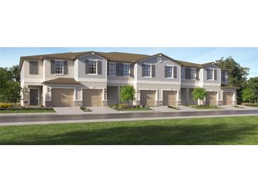 Charming townhomes with attached garages, landscaped yards, and neutral color palettes, creating an inviting neighborhood at 2668 Buttercup Lucine Ln, Ruskin, FL 33570
