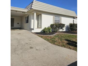 Charming single-story home with a well-maintained front yard and covered parking at 4043 La Pasida Ln, New Port Richey, FL 34655