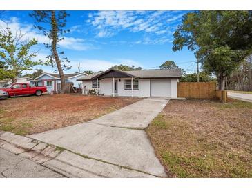 Charming single-story home with a long driveway and attached garage, ready for new owners at 5911 63Rd N Ter, Pinellas Park, FL 33781