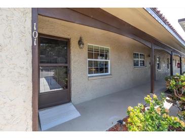 Inviting front porch with brown door and window, leading into a charming home at 601 N Hercules Ave # 101, Clearwater, FL 33765