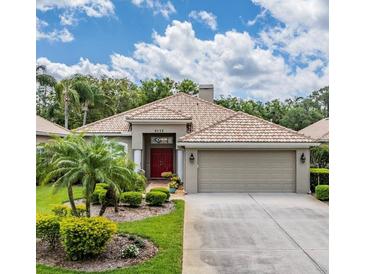 Beautiful single-story home featuring a well-maintained lawn and mature landscaping at 5132 Pinnacle Dr, Oldsmar, FL 34677