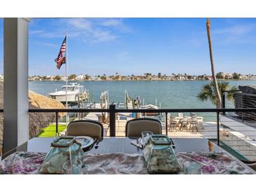 Breathtaking waterfront views from the dining table, overlooking the boat dock and serene water at 5820 Balao S Way, St Pete Beach, FL 33706