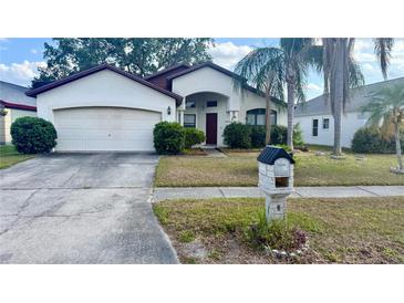 Charming single-story home featuring a well-maintained front yard, two-car garage, and inviting front entrance at 1510 Sakonnet Ct, Brandon, FL 33511