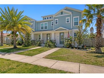 Charming two-story townhome with a well-maintained lawn and tropical landscaping in a residential community at 2708 W North B St # 3, Tampa, FL 33609