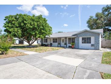Charming single-story home featuring a well-maintained front yard and a concrete driveway on a sunny day at 9118 108Th Ave, Seminole, FL 33777