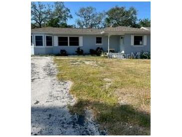Charming single-story home featuring a well-maintained lawn and a welcoming entrance at 1379 Pine St, Clearwater, FL 33756