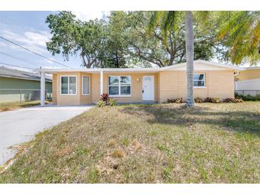 Charming single-story home with a white door and well-maintained front yard at 13926 Helen Ave, Hudson, FL 34667